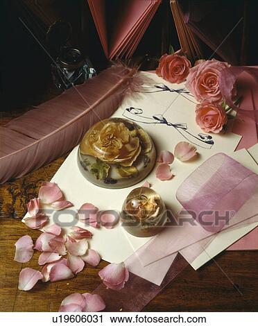 Still-Life of pink roses and rose petals with rose paper-weight on cream writing paper View Large Photo Image Stock Image - Still-Life of pink roses and rose petals with rose paper-weight on cream writing paper. Fotosearch