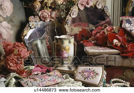 Stock Image - Still-Life of Victorian vases and mirrors with ceramic rose-encrusted frames. Fotosearch