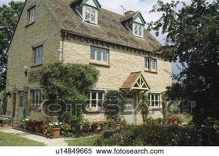 Stone country cottage with porch and dormer windows View Large Photo Image Stock Photography - Stone country cottage with porch and dormer windows. Fotosearch