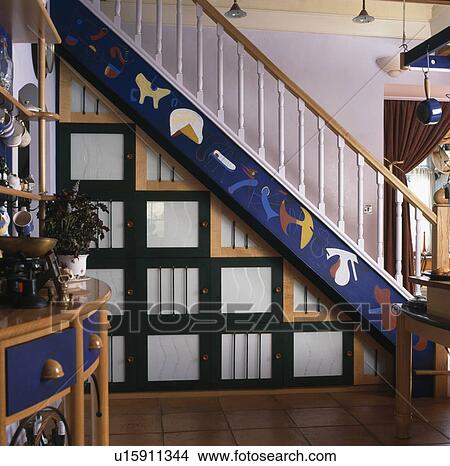 Storage boxes below decorated blue staircase View Large Photo Image Picture - Storage boxes below decorated blue staircase. Fotosearch