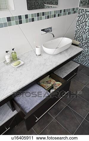 Storage drawers below bowl-style basin on marble-topped vanity unit View Large Photo Image Stock Image - Storage drawers below bowl-style basin on marble-topped vanity unit . Fotosearch