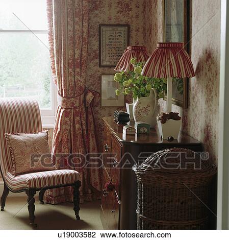 Striped upholstered chair in front of window with pink floral curtain View Large Photo Image Stock Image - Striped upholstered chair in front of window with pink floral curtain. Fotosearch