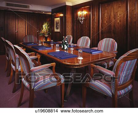 Picture - Striped upholstered chairs in panelled office boardroom. Fotosearch