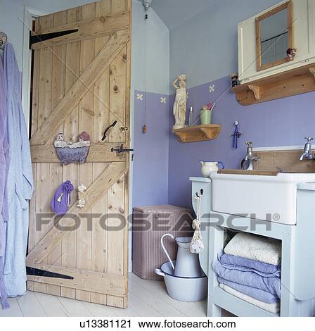 Stripped pine door in blue cottage bathroom View Large Photo Image Stock Image - Stripped pine door in blue cottage bathroom. Fotosearch