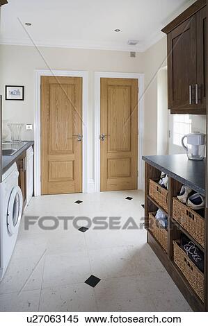 Synthetic Stonell flooring with black granite inlays in modern white kitchen View Large Photo Image Stock Photography - Synthetic Stonell flooring with black granite inlays in modern white kitchen. Fotosearch