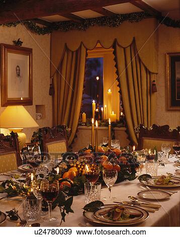 Table decorated for Christmas dinner in cottage dining room View Large Photo Image Stock Photo - Table decorated for Christmas dinner in cottage dining room. Fotosearch