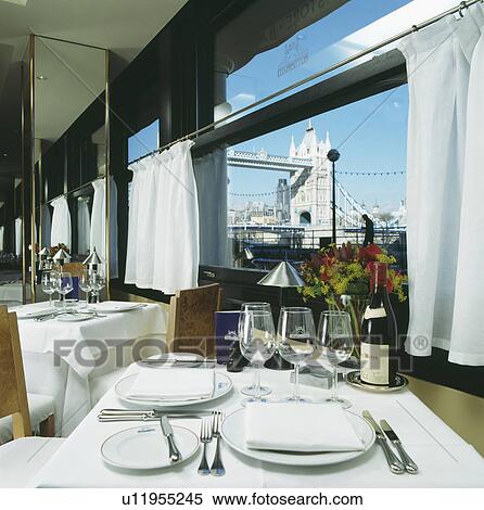 Table set for lunch in front of window at the Pont de la Tour restaurant in London with view of Tower Bridge View Large Photo Image Stock Photography - Table set for lunch in front of window at the Pont de la Tour restaurant in London with view of Tower Bridge. Fotosearch