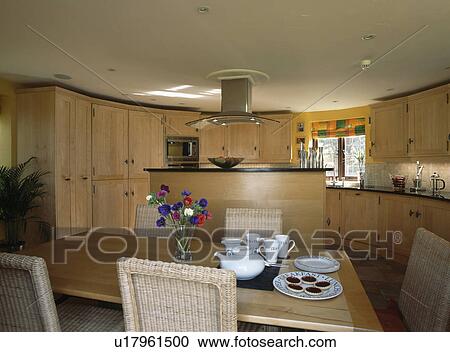 Stock Image - Table set for tea in modern country kitchen. Fotosearch