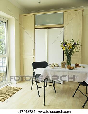 Picture - Table with white cloth in modern kitchen dining room with wooden flooring. Fotosearch
