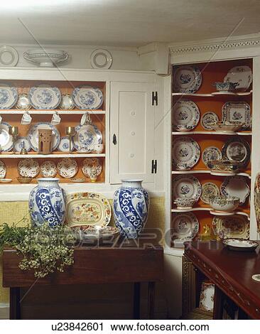 Tall blue+white vases on table in cottage dining room with antique china on alcove shelves View Large Photo Image Stock Image - Tall blue+white vases on table in cottage dining room with antique china on alcove shelves. Fotosearch