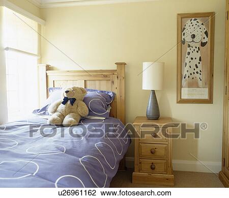 Teddybear on pine bed with blue duvet in child's bedroom View Large Photo Image Stock Image - Teddybear on pine bed with blue duvet in child's bedroom. Fotosearch