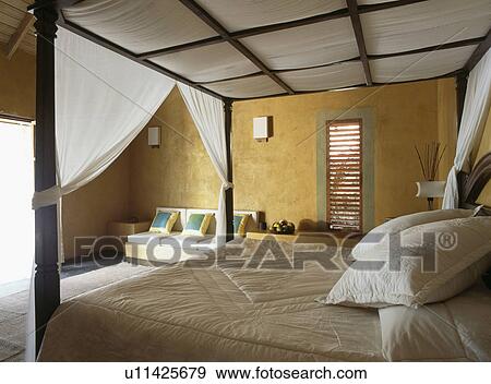 Tented drapes on bed in yellow bedroom View Large Photo Image Stock Photo - Tented drapes on bed in yellow bedroom. Fotosearch