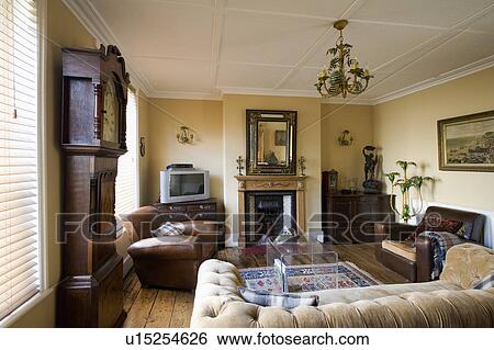 Thirties leather club chairs and perspex table in living room with antique mirror above fireplace View Large Photo Image Stock Photograph - Thirties leather club chairs and perspex table in living room with antique mirror above fireplace. Fotosearch