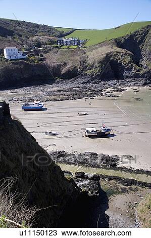 Stock Image - Tide out on Cornish beach. Fotosearch
