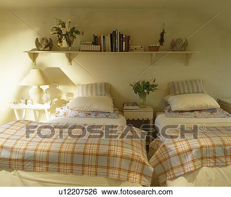 Stock Photograph - Toile-de-Jouy curtain beside glass door to shower in bathroom with towels on shelves. Fotosearch