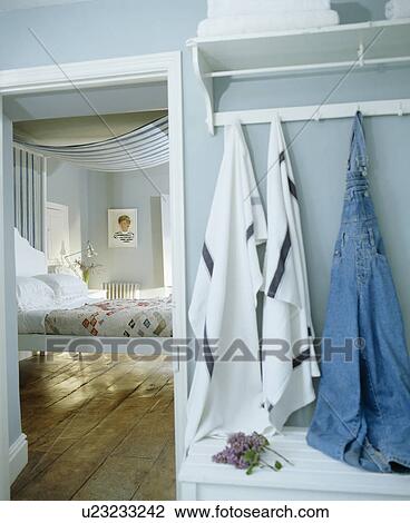 Towels on pegboard beside open door to pastel blue bedroom View Large Photo Image Stock Image - Towels on pegboard beside open door to pastel blue bedroom. Fotosearch