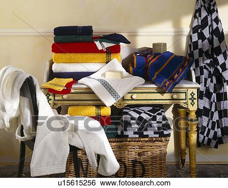 Towels stacked on table with bathrobes on chair and hanging on wall View Large Photo Image Stock Photograph - Towels stacked on table with bathrobes on chair and hanging on wall. Fotosearch
