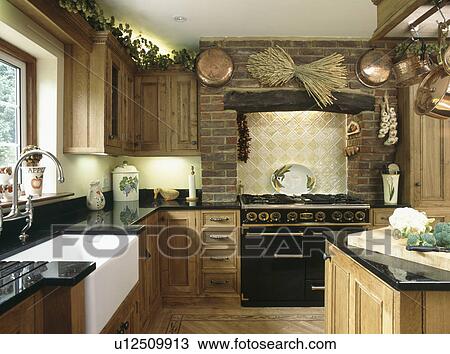Traditional country kitchen with Belfast sink and black Aga oven View Large Photo Image Stock Image - Traditional country kitchen with Belfast sink and black Aga oven. Fotosearch