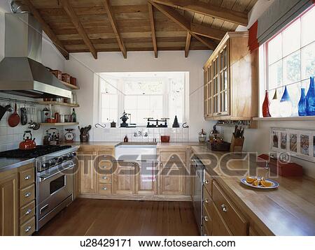 Traditional kitchen with beamed ceiling and fitted birch units View Large Photo Image Stock Image - Traditional kitchen with beamed ceiling and fitted birch units . Fotosearch