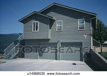 Traditional wood-clad house painted green with double garage View Large Photo Image Stock Photography - Traditional wood-clad house painted green with double garage. Fotosearch