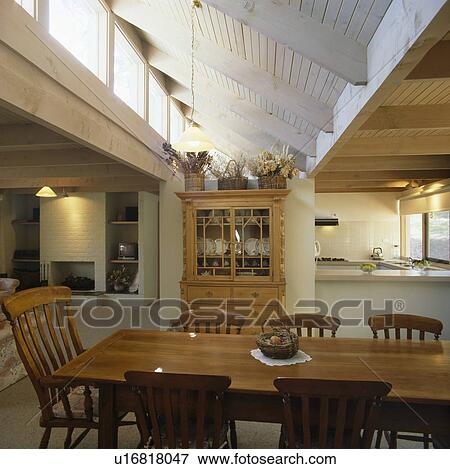 Traditional wooden table and chairs in large modern openplan dining room View Large Photo Image Stock Photo - Traditional wooden table and chairs in large modern openplan dining room. Fotosearch