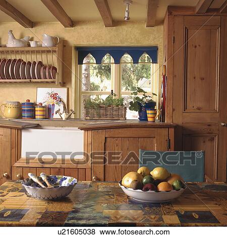 Stock Photo - Traditional yellow cottage kitchen. Fotosearch
