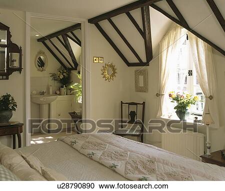 Tradtional white attic bedroom with door to ensuite bathroom View Large Photo Image Stock Image - Tradtional white attic bedroom with door to ensuite bathroom. Fotosearch