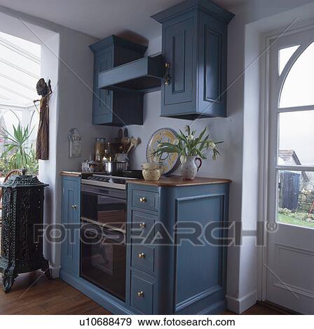 Tricity cooker and hob in fitted blue kitchen View Large Photo Image Stock Photo - Tricity cooker and hob in fitted blue kitchen. Fotosearch