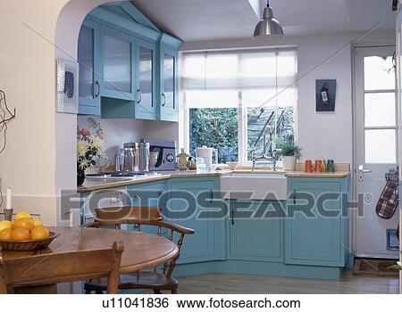 Turquoise fitted units in modern white kitchen dining room View Large Photo Image Stock Photograph - Turquoise fitted units in modern white kitchen dining room. Fotosearch