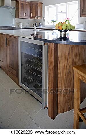 Undermounted wine cooler in modern walnut kitchen View Large Photo Image Stock Image - Undermounted wine cooler in modern walnut kitchen. Fotosearch