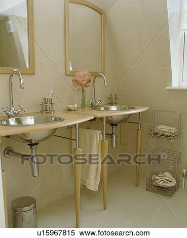 Underset stainless-steel basins in pale wood vanity unit in modern cream bathroom View Large Photo Image Stock Photography - Underset stainless-steel basins in pale wood vanity unit in modern cream bathroom. Fotosearch
