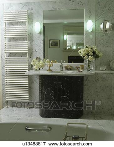 Vertical radiator beside mirror and marble vanity unit in modern bathroom View Large Photo Image Stock Photo - Vertical radiator beside mirror and marble vanity unit in modern bathroom. Fotosearch
