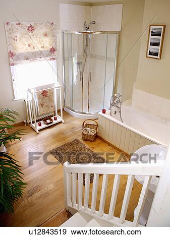 Stock Photo - View down staircase of bathroom with corner shower and wooden flooring . Fotosearch