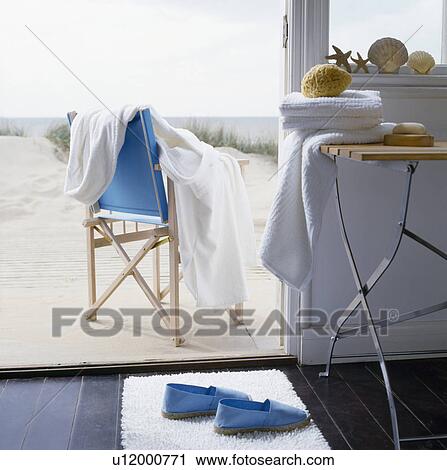 View from beach hut of sandy deck with white bathrobe on blue director's chair View Large Photo Image Stock Image - View from beach hut of sandy deck with white bathrobe on blue director's chair . Fotosearch
