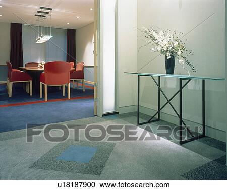 Stock Image - View from hallway of red chairs in modern office boardroom. Fotosearch