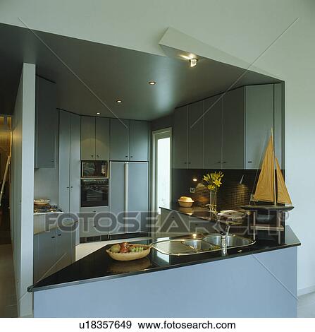 Stock Photo - View through hatch of modern grey kitchen. Fotosearch