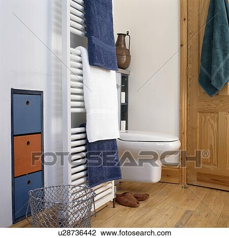 White and blue towels on vertical radiator in small modern bathroom View Large Photo Image Stock Image - White and blue towels on vertical radiator in small modern bathroom. Fotosearch