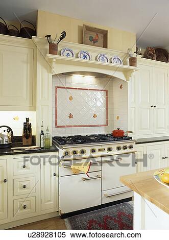 White and red wall tiles above white range oven in white kitchen View Large Photo Image Stock Photography - White and red wall tiles above white range oven in white kitchen. Fotosearch