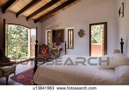 White bedlinen on bed in airy white Mallorcan bedroom with French doors to balcony View Large Photo Image Stock Image - White bedlinen on bed in airy white Mallorcan bedroom with French doors to balcony. Fotosearch