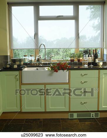 White blind on window above Belfast sink in country kitchen with pale green fitted units View Large Photo Image Stock Image - White blind on window above Belfast sink in country kitchen with pale green fitted units. Fotosearch