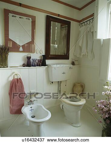 White cottage bathroom with white bidet and toilet View Large Photo Image Stock Photo - White cottage bathroom with white bidet and toilet. Fotosearch