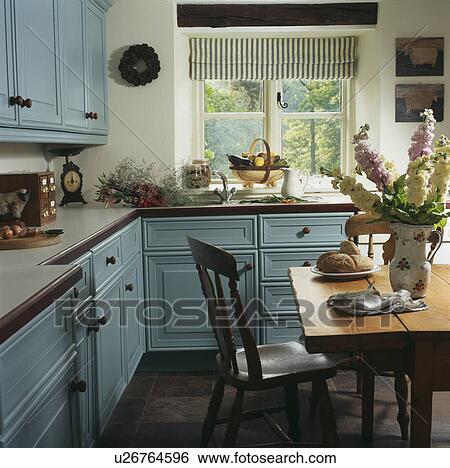 White cottage kitchen with pastel blue units and striped blind on window View Large Photo Image Stock Photograph - White cottage kitchen with pastel blue units and striped blind on window. Fotosearch