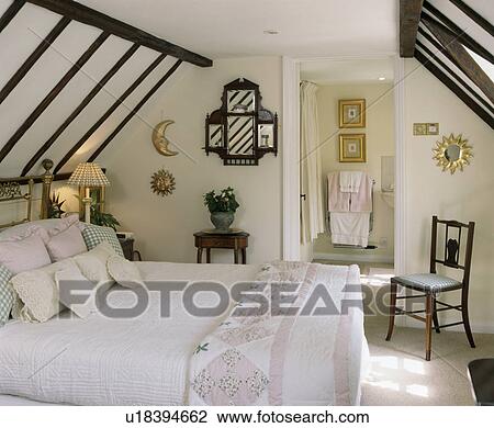 Stock Image - White country attic bedroom. Fotosearch