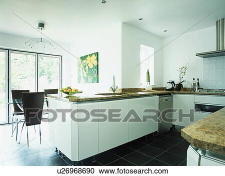 White fitted units in modern white kitchen dining room View Large Photo Image Stock Image - White fitted units in modern white kitchen dining room. Fotosearch