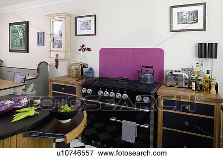 White kitchen with black mercury range oven with purple splashback View Large Photo Image Stock Photo - White kitchen with black mercury range oven with purple splashback. Fotosearch