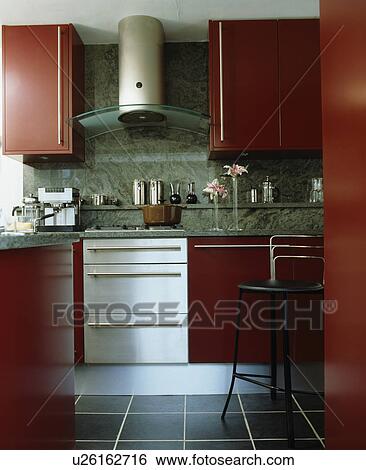 White oven below glass and steel extractor in modern red kitchen View Large Photo Image Stock Photograph - White oven below glass and steel extractor in modern red kitchen. Fotosearch