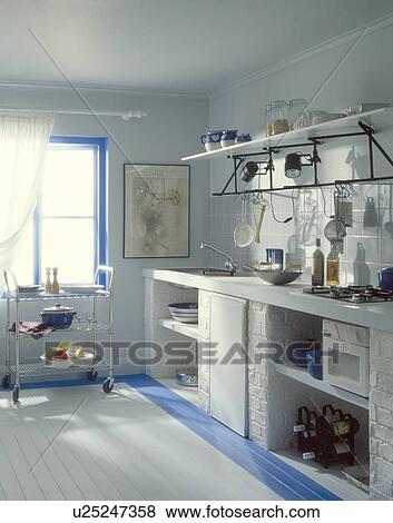White painted wooden floor with blue border in white economy-style seventies kitchen View Large Photo Image Stock Photo - White painted wooden floor with blue border in white economy-style seventies kitchen. Fotosearch