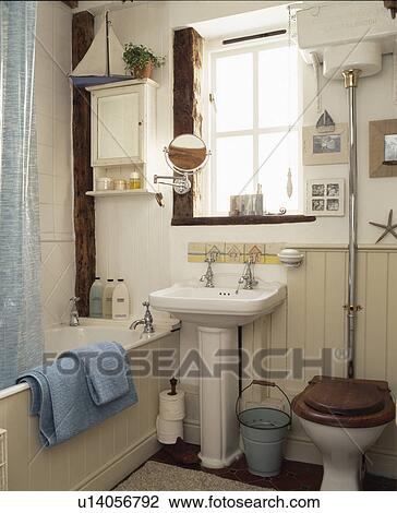 White Pedestal Basin Below Window In Cottage Bathroom Stock Image White Pedestal Basin Below Window In