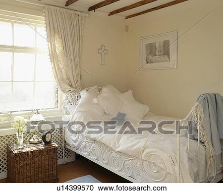 White pillows and bedlinen on white cast-iron bed in cottage bedroom View Large Photo Image Stock Image - White pillows and bedlinen on white cast-iron bed in cottage bedroom. Fotosearch