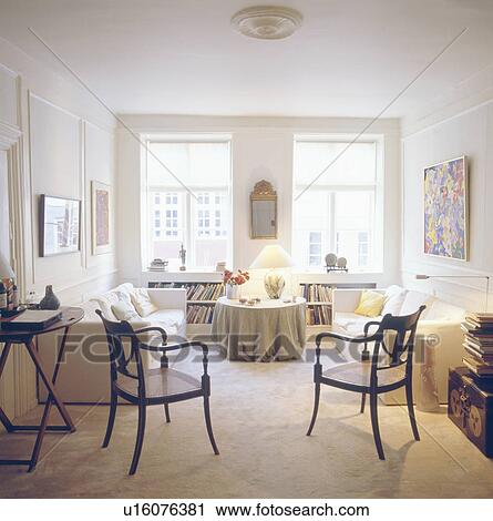 White sofas and antique dining chairs in apartment living room with cream carpet View Large Photo Image Stock Image - White sofas and antique dining chairs in apartment living room with cream carpet. Fotosearch